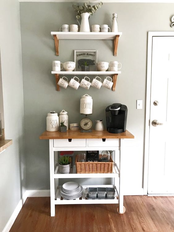 a cozy home bar with an IKEA Forhoja cart with a butcher block countertop and open shelves over it