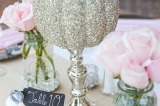 a gold glitter pumpkin on a mercury glass stand is a bright and fun centerpiece for the fall