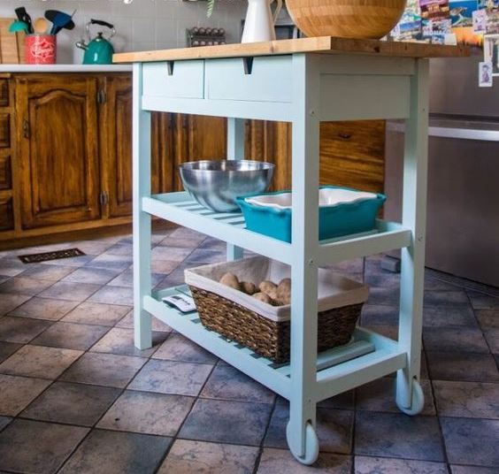 a light blue IKEA Forhoja cart with a wooden countetop as a small and cute kitchen island