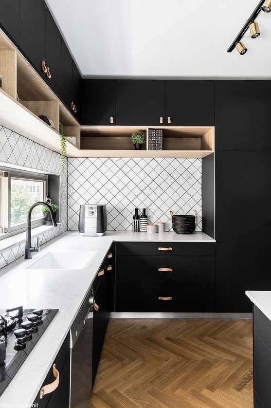 a modern black kitchen with a geometric backsplash and white countertops plus touches of wood