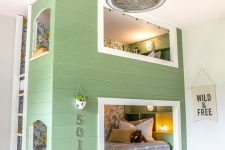 a modern farmhouse kids’ room with a green house-shaped built-in bunk bed, a ladder, numbers and potted plants looks unusual and super eye-catchy