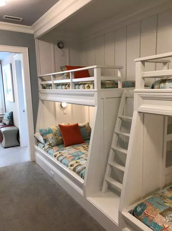 a modern kids' room with built-in bunk beds, bright printed bedding, built-in lights is a cool and welcoming space for children