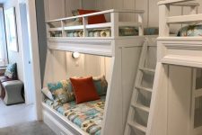 a modern kids’ room with built-in bunk beds, bright printed bedding, built-in lights is a cool and welcoming space for children
