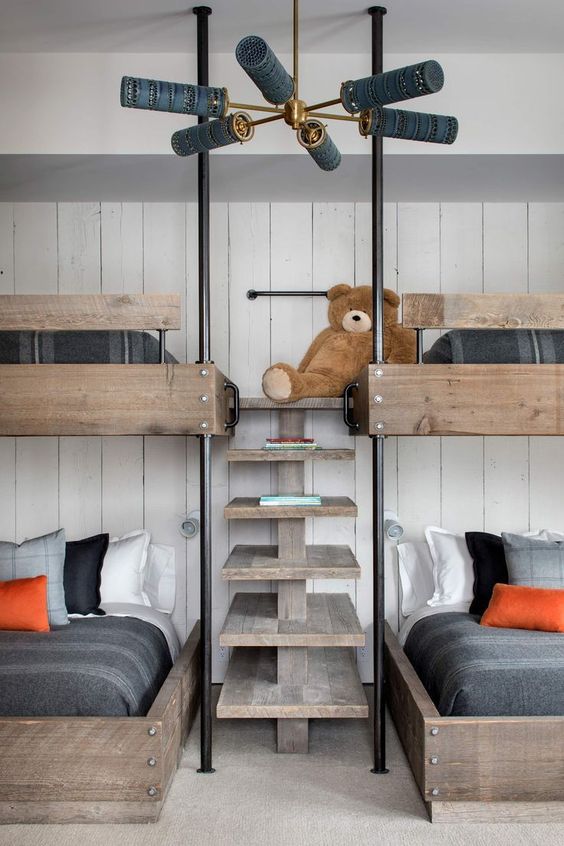 a modern rustic kids' room with a white shiplap wall, stained bunk beds with a wooden ladder and moody bedding is a stylish solution