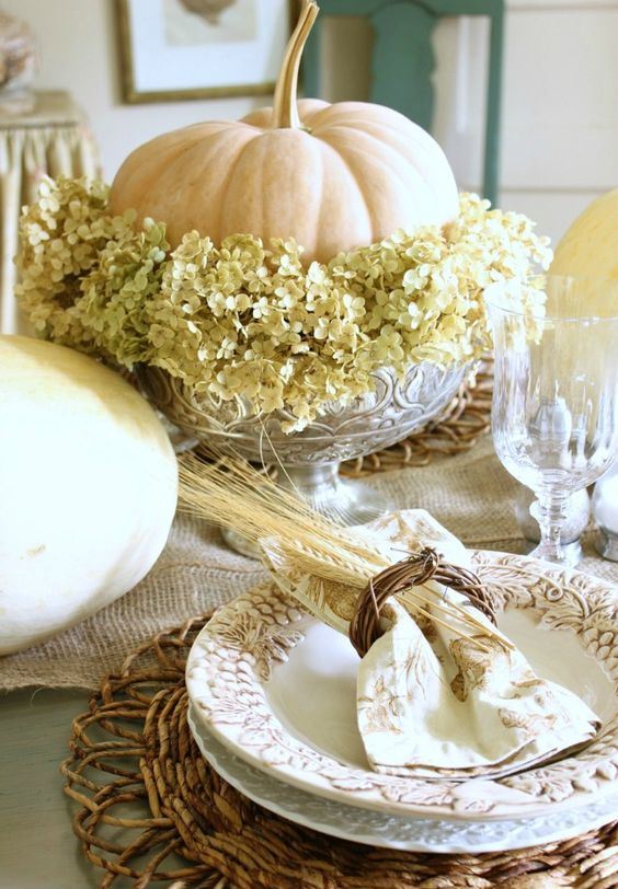 a neutral pumpkin, green hydrangeas in a crystal bowl form a gorgeous natural fall centerpiece