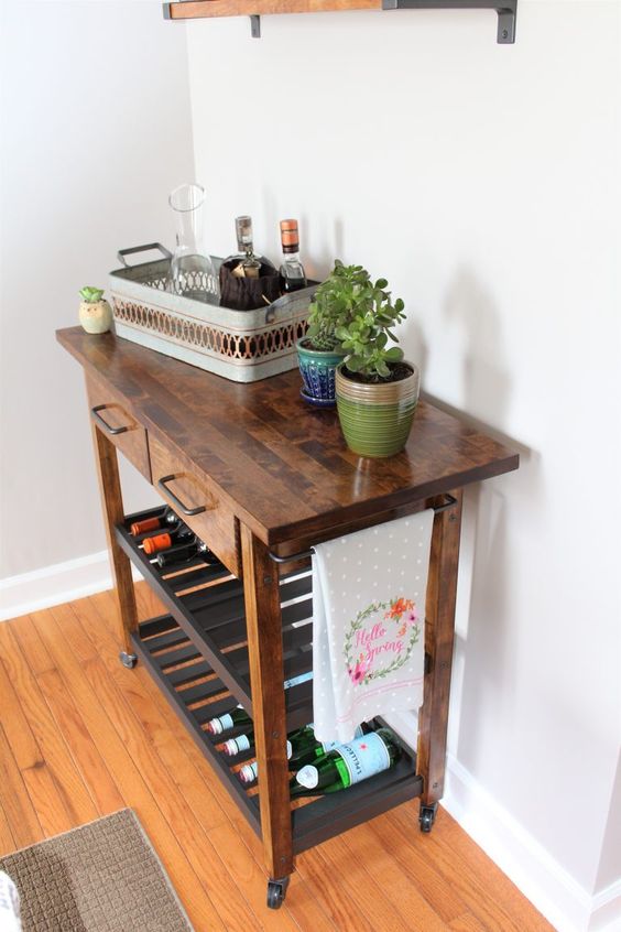 a rich stained IKEA Forhoja cart with a butcher block countertop becomes a mid-century modern home bar