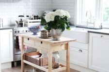a small and chic kitchen island of an IKEA Forhoja cart with plenty of storage and a countertop