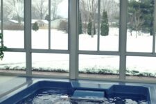 a small and lovely white pool house with a plunge pool and glazed walls to enjoy the views is a great idea in any weather and season