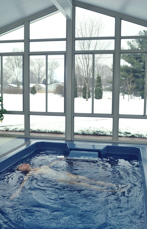 a small and lovely white pool house with a plunge pool and glazed walls to enjoy the views is a great idea in any weather and season