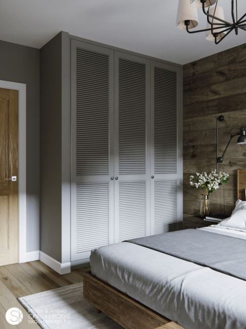a small bedroom with floor to ceiling cabinets to make it look bigger and give more storage space