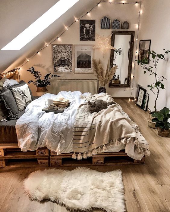 a small neutral bedroom looks bigger thanks to the skylight and neutral shades chosen for decor