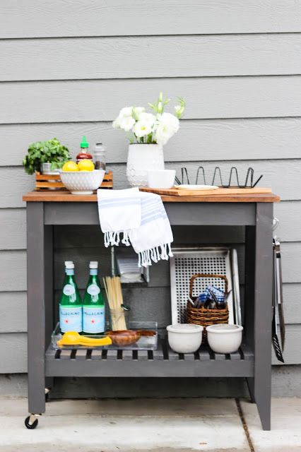 a stylish outdoor bar or grill cart made of an IKEA Forhoja cart painted graphite grey and with a wooden countertop
