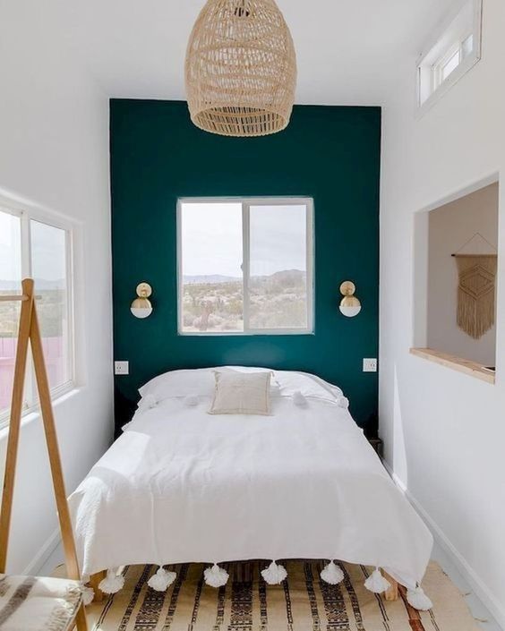 a tiny bedroom enlargened with a neutral color scheme, a mirror and several windows and feels welcoming