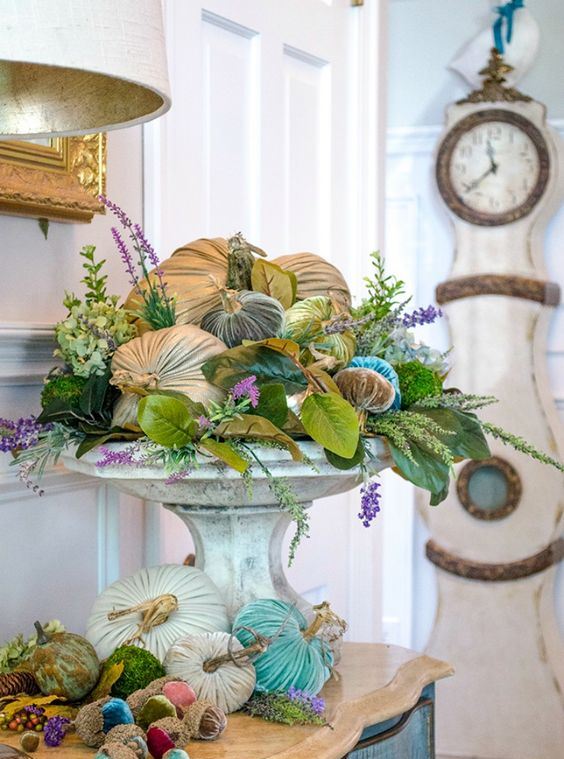 a vintage stone stand with faux greenery and leaves, blooms and velvet pumpkins for timeless fall decor