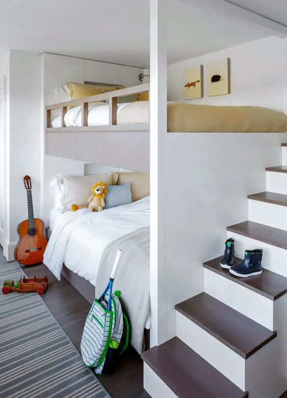 a welcoming neutral kids' room with built in bunk beds, with neutral bedding and a ladder, a striped rug and some pretty toys and other stuff