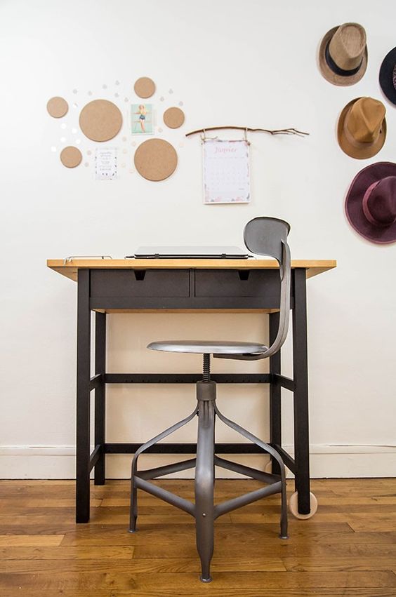 a working space with a black IKEA Forhoja cart with a neutral wooden countertop and a matching black chair