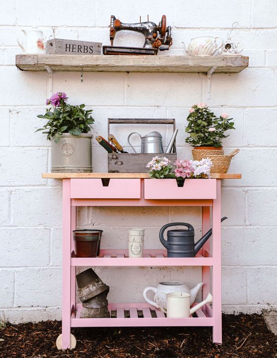 an IKEA Forhoja cart done in millenial pink used for planting and for gardening is a very cute piece