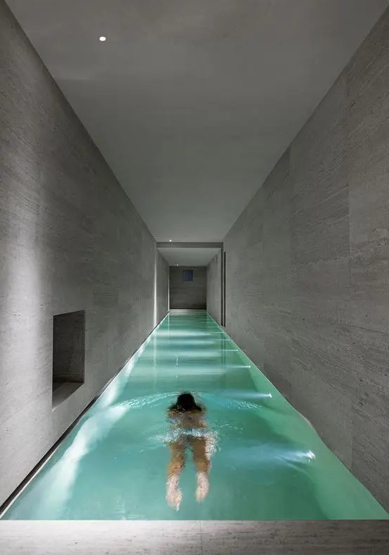 an extra long and narrow lit up pool with some niches will be a great solution for a minimalist home