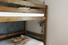 dark stained bunk beds and railing along the upper bed to keep the kid safe