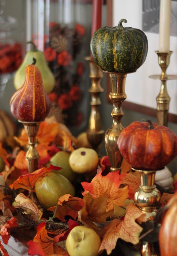 faux pumpkins and pearls on metallic stands, with faux leaves and veggies under them for a chic fall arrangement