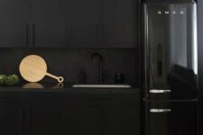 matte black cabinets, a matte black backsplash and a black shiny fridge for an edgy moody kitchen