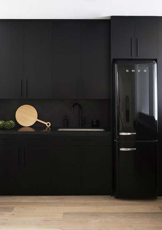 matte black cabinets, a matte black backsplash and a black shiny fridge for an edgy moody kitchen