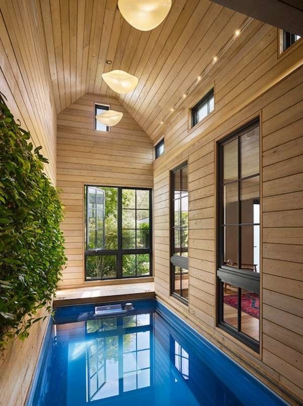 this plunge pool is sandwiched inside the atrium, and chestnut paneling around is perfectly complemented by blue water