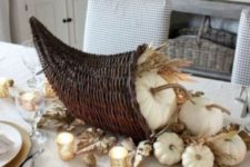 a cornucopia Thanksgiving centerpiece with white pumpkins, wheat and gold leaves plus nuts