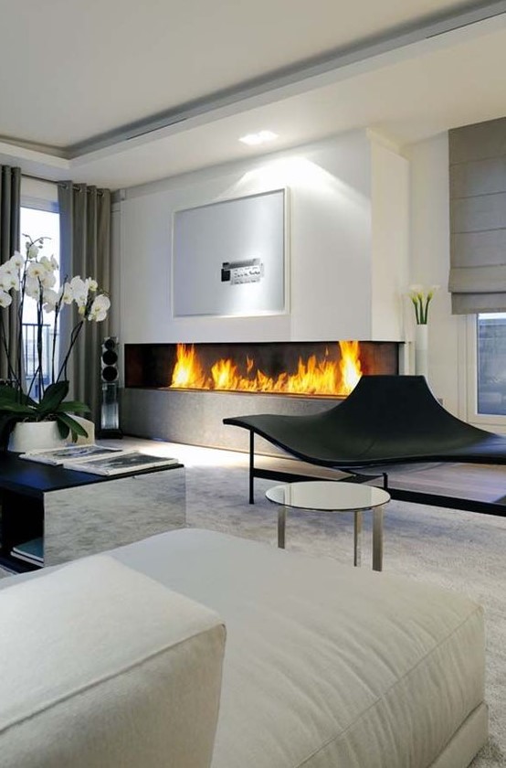 a large minimalist built-in fireplace in the living room is a stylish and bold idea with a modern feel