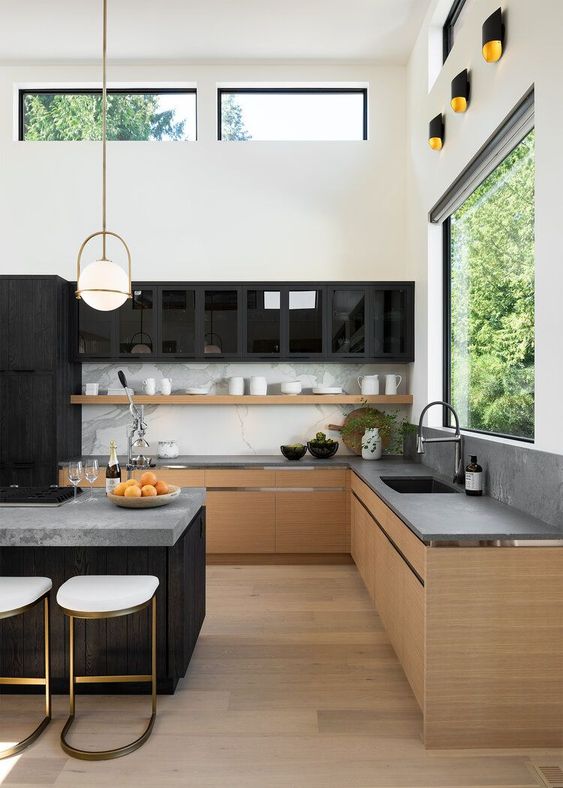 a minimalist kitchen with contrasts, with stained cabinets, concrete countertops and a backspalsh, black upper cabinets and a large kitchen island with seats