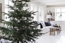 a modern Scandi Christmas tree with silver, white and clear ornaments and no lights is a stylish idea for your neutral space