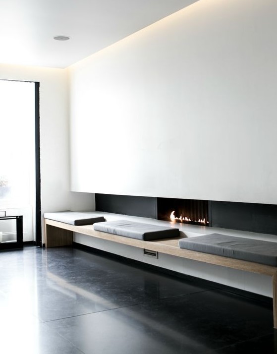 a modern ethanol fireplace, a comfy bench next to it bring a touch of luxury to the interior