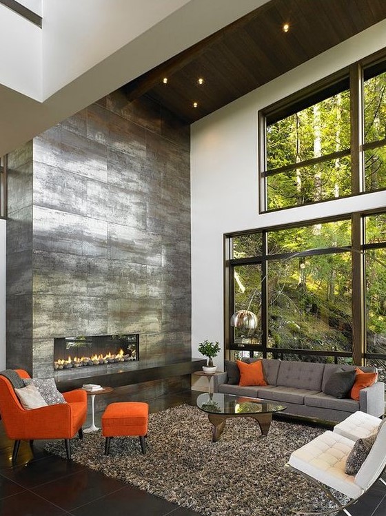 a shiny sleek metal fireplace that takes a whole wall will become a centerpiece of any living room and make it bolder