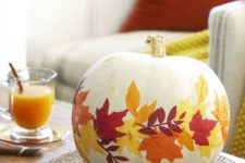 a white pumpkin with bright fall leaves decoupaged is a cool idea for the fall and will last long if you take a faux pumpkin