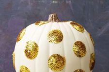 a white pumpkin with large gold sequin polka dots will give a cool glam feel to your Thanksgiving decor