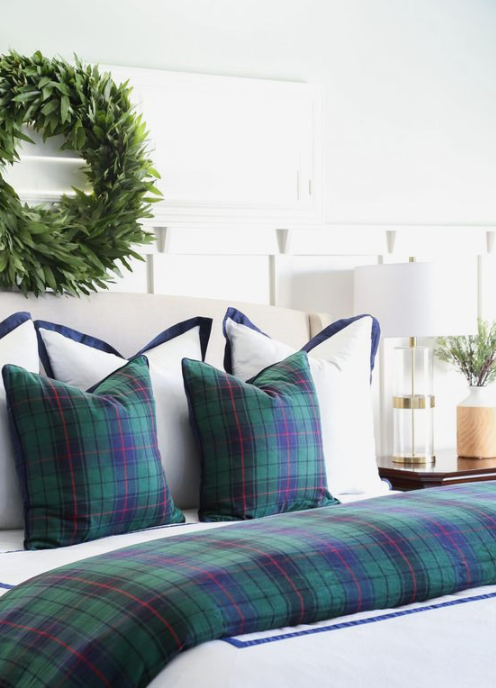 dark plaid bedding and a greenery wreath will easily transform your bedroom into a wintry space