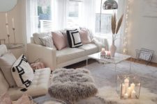 layered fur rugs, a fur stool and a fur blanket make the living room more welcoming and cozy