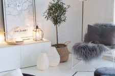 lots of fairy lights here and there and candle lanterns make this Scandinavian living room very cozy
