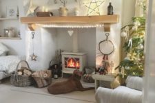 lots of lights on the tree, mantel and a lit up star for cool holiday decor with a natural feel