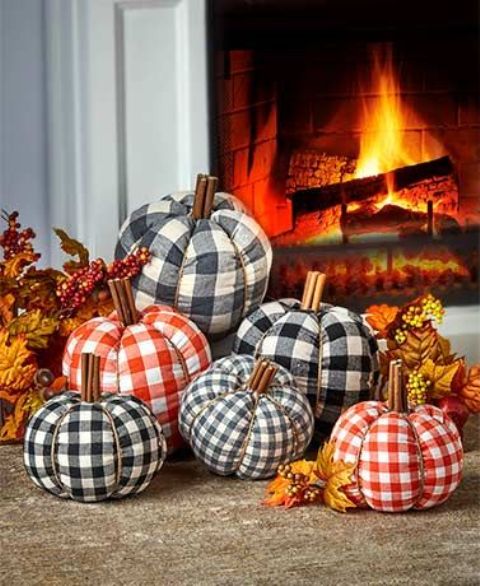 lovely plaid pumpkins in orange, grey and black, with faux leaves compose lovely fall or Thanksgiving decor