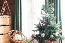 a Christmas tree in a basket with colorful and pretty ornaments is a lovely decoration for the holidays and it will look amazing always