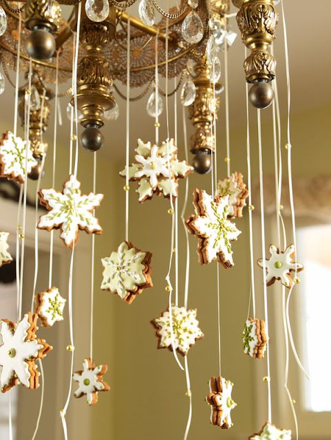 a chandelier decorated with glazed snowflake-shaped gingerbread cookies is a creative idea for a Christmas kitchen
