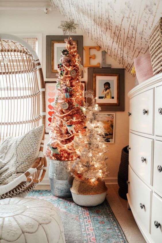a duo of Christmas trees with lights and various ornaments and decor is a perfect idea for pulling off holiday decor in your kids' room