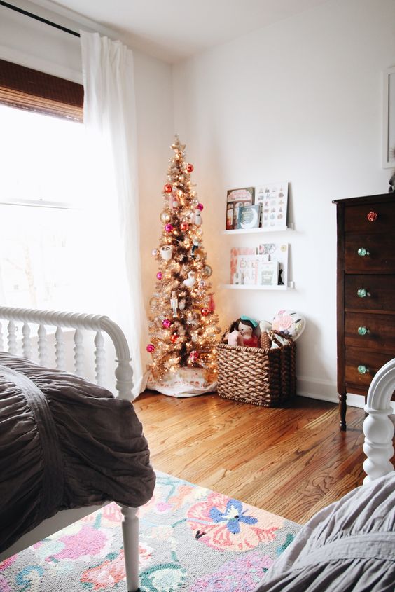 a gold Christmas tree with colorful ornaments is all you need to create a feeling of holidays in your kids' room