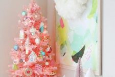 a hot pink Christmas tree with fun and whimsical ornaments and a cookie tree topper for creating a holiday feel in the space