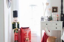 a red stocking, a red box for letters to Santa and a vintage toy for creating a holiday atmosphere in the space