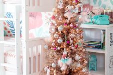 a shiny metallic Christmas tree with bright ornaments and a pink faux fur tree skirt will add a holiday feel to the space