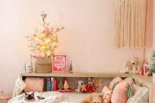 a small flocked Christmas tree with lights and pastel ornaments is a cool and easy solution to bring a feeling of holidays to the room