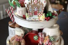 a stand with bright berries, kitchen stuff, sweets, a small and bright gingerbread house and felt gingerbread men