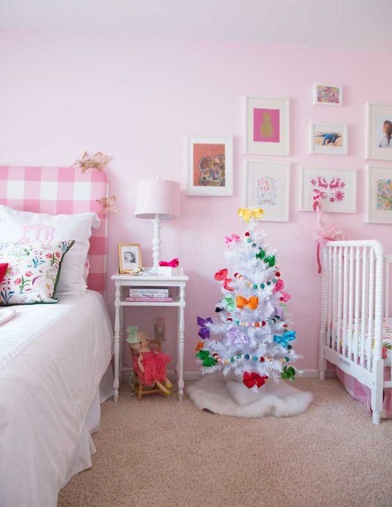 a white Christmas tree with colorful bows and bright pompom garlands will easily bring a festive feel to the space